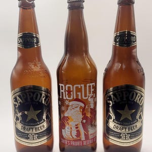 Trio de Garrafas de Cerveja Colecionáveis: Reserva do Papai Noel Rebelde + Chope de Sapporo