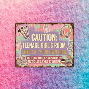 May include: A rectangular metal sign with a distressed finish, featuring the text "CAUTION: TEENAGE GIRL'S ROOM. ENTER AT YOUR OWN RISK." and other phrases. The sign includes illustrations of makeup brushes, perfume, headphones, a phone, sneakers, and a cat.
