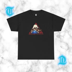 May include: A black short-sleeve t-shirt featuring a graphic print of a figure with long hair reaching for a blue orb inside a red triangle. Below the graphic, the text reads OSAMASON PSYROTIC. A small letter T logo is printed on the inner neck label.
