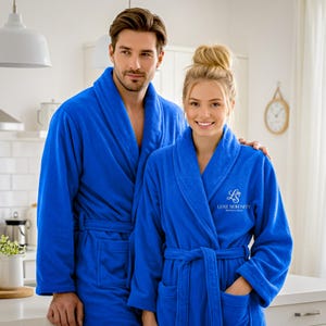 May include: A white ceramic mug with a black handle and the text "But First, Coffee" in a black, bold font. The mug is sitting on a wooden surface.