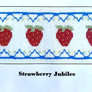 May include: A white and blue cross-stitch pattern featuring a row of red strawberries with green leaves and white flowers. The pattern is titled "Strawberry Jubilee" and includes the copyright information "COPYRIGHT USA © CROSS-EYED CRICKET, 2021.  Pattern #100".