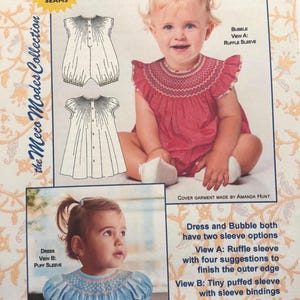 May include: A sewing pattern for baby dresses and bubbles, featuring two children modeling the garments. The pattern includes options for ruffle or puffed sleeves, with sizes ranging from newborn to 24 months. The cover art is by Amanda Hunt.