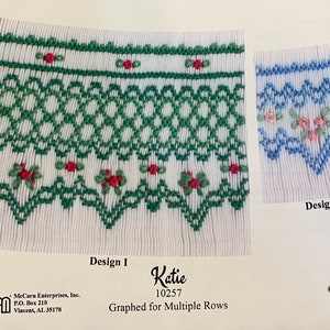 May include: Two embroidery designs for a white fabric. Design I features a green and red floral pattern with the text "Design I". Design II features a blue and pink floral pattern with the text "Design II". The text "Katie 10257 Graphed for Multiple Rows" is also included.