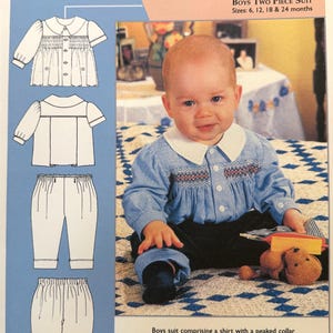 May include: A baby wearing a blue and white checkered shirt with a white collar and black pants. The image includes a diagram of a two-piece suit and text that reads "Boys Two Piece Suit" and "Meco Modes".