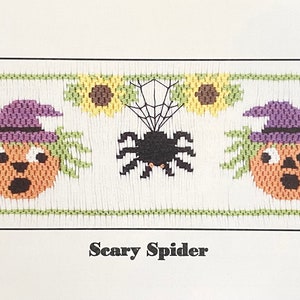 May include: Cross-stitch pattern for a Halloween-themed design featuring two orange jack-o'-lantern faces with purple witch hats and green hair, a black spider with a web, and two yellow sunflowers. The pattern is titled "Scary Spider".
