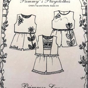 May include: A sewing pattern envelope titled Primrose Lane Pammy's Playclothes for child's top and shorts sizes 3-8. The black and white line drawing shows three variations of sleeveless tops and shorts with floral and butterfly embellishments.