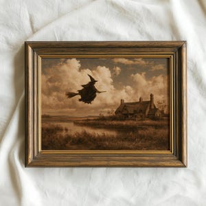 May include: A rectangular framed wall art piece featuring a sepia-toned illustration of a figure in a pointed hat flying on a broomstick over a landscape with a cottage, a river, and tall grass under a cloudy sky, enclosed in a dark wood frame.