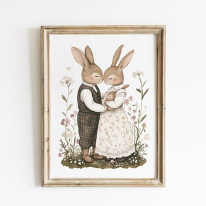 May include: A watercolor illustration of two brown rabbits, one holding a smaller rabbit, standing in a field of pink and white flowers. The rabbits are wearing clothes and are looking at each other.