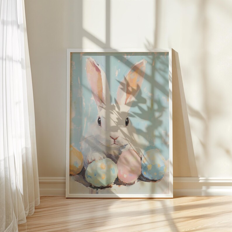 May include: A white rabbit with pink ears sits surrounded by pastel colored Easter eggs. The rabbit is looking at the viewer with a curious expression. The background is a light blue with a shadow of a plant.