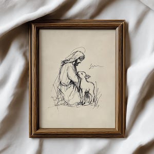 May include: A framed pen and ink drawing depicts a figure with a halo, kneeling beside a lamb. The artwork is in a brown wooden frame. The drawing is on a cream-colored background.