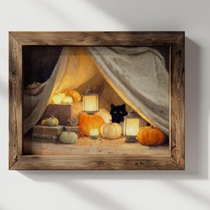 May include: A framed painting of a Halloween scene. A black cat is visible behind a draped cloth, surrounded by pumpkins, lit lanterns, and candles. The artwork is set in a wooden frame.
