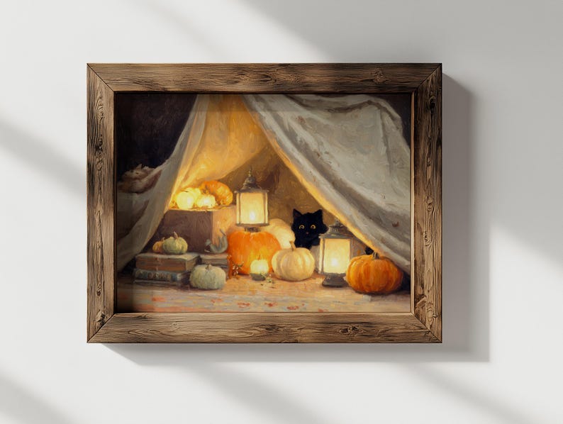 May include: A framed painting of a Halloween scene. A black cat is visible behind a draped cloth, surrounded by pumpkins, lit lanterns, and candles. The artwork is set in a wooden frame.