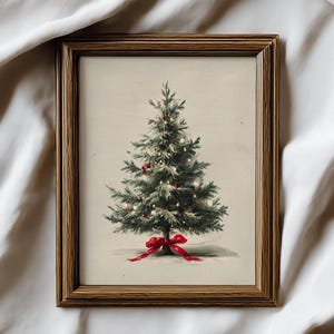 May include: A framed wall art print featuring a green Christmas tree with small white lights and red ornaments. A bright red ribbon bow is tied at the base of the tree trunk. The artwork is enclosed in a dark brown wooden frame with a textured finish.
