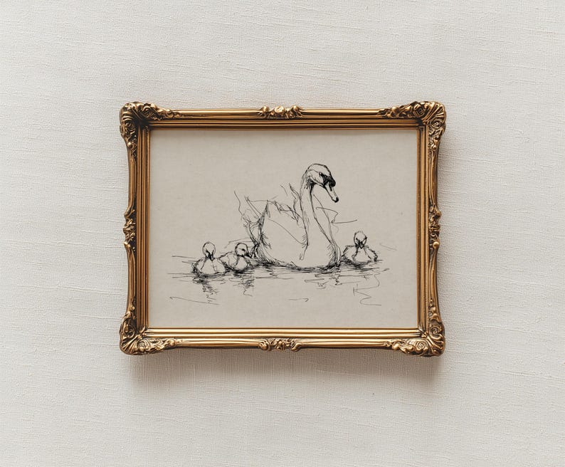 May include: A framed pen and ink drawing of a swan with three cygnets swimming in water. The artwork is in a gold ornate frame. The drawing is in black and white, with the swan and cygnets rendered in fine lines.