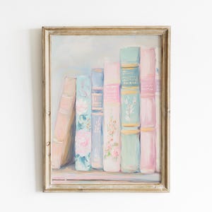 May include: A framed painting of a row of vintage books with pastel pink, blue, and green covers. The books are arranged on a shelf and have floral designs on the spines.
