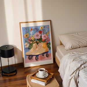 May include: A framed print of a painting depicting a pair of roller skates with a bouquet of colourful flowers in a yellow vase. The background is a light blue.