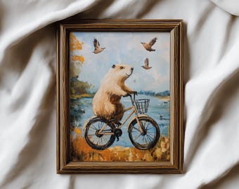 Impresión digital de un carpincho en bicicleta, divertido animal de descarga instantánea. Imprimible de arte mural con un lindo roedor ciclista, regalo único para habitación infantil.