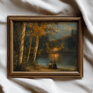 May include: A framed landscape painting depicts a serene lakeside scene. The artwork features a warm color palette with autumnal trees, a calm lake reflecting lights, and two figures seated on the shore. The frame is a warm brown color.