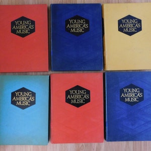 May include: Six hardcover books with the title "Young America's Music" on the front cover. The books are in different colors: red, blue, yellow, turquoise, and dark blue.