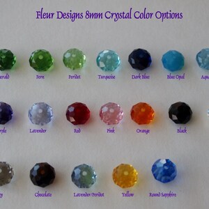 May include: A chart showing 8mm crystal color options for jewelry making. The colors include emerald, fern, peridot, turquoise, dark blue, blue opal, aquamarine, deep purple, lavender, red, pink, orange, black, clear AB, gray, chocolate, lavender/peridot, yellow, and round sapphire.