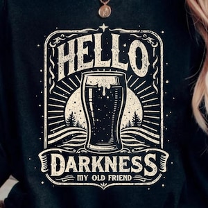 May include: Black t-shirt with a vintage-style graphic of a beer glass and the text "Hello Darkness My Old Friend".