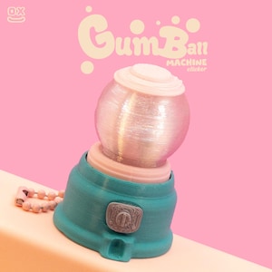 Może przedstawiać: Turkusowa i różowa naklejka z automatem do gumy z napisem "Gumball Machine sticker" na różowym tle. Automat do gumy ma przezroczysty, kulisty wierzch i turkusową podstawę z małym, szarym guzikiem.