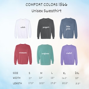 May include: A display of Comfort Colors 1566 unisex sweatshirts in various colors: white, pepper, blue jean, crimson, seafoam, and violet. Size chart shows width from 21" to 28" and length from 27.5" to 31.5".