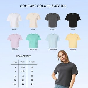 May include: A display of Comfort Colors Boxy Tees in various colors: white, ivory, pepper, black, orchid, chalky mint, chambray, and butter. The image includes a measurement chart with sizes ranging from S to 2XL, with widths from 18 1/4 to 26 inches and lengths from 20 to 24 inches.