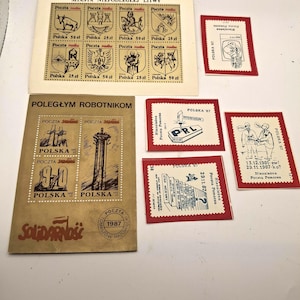 May include: A collection of Polish postage stamps and souvenir sheets from 1987. The items feature black ink illustrations on cream and red paper, including historical emblems, Solidarity movement imagery, and text such as Miasta Niepodleglej Litwy.