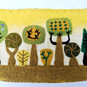 May include: A felt clutch bag with a whimsical design of trees in shades of green, yellow, and brown. The trees have unique shapes and textures, creating a playful and artistic look.