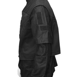 May include: Black tactical vest with multiple pockets and adjustable straps. The vest has a high collar and a zipper closure.