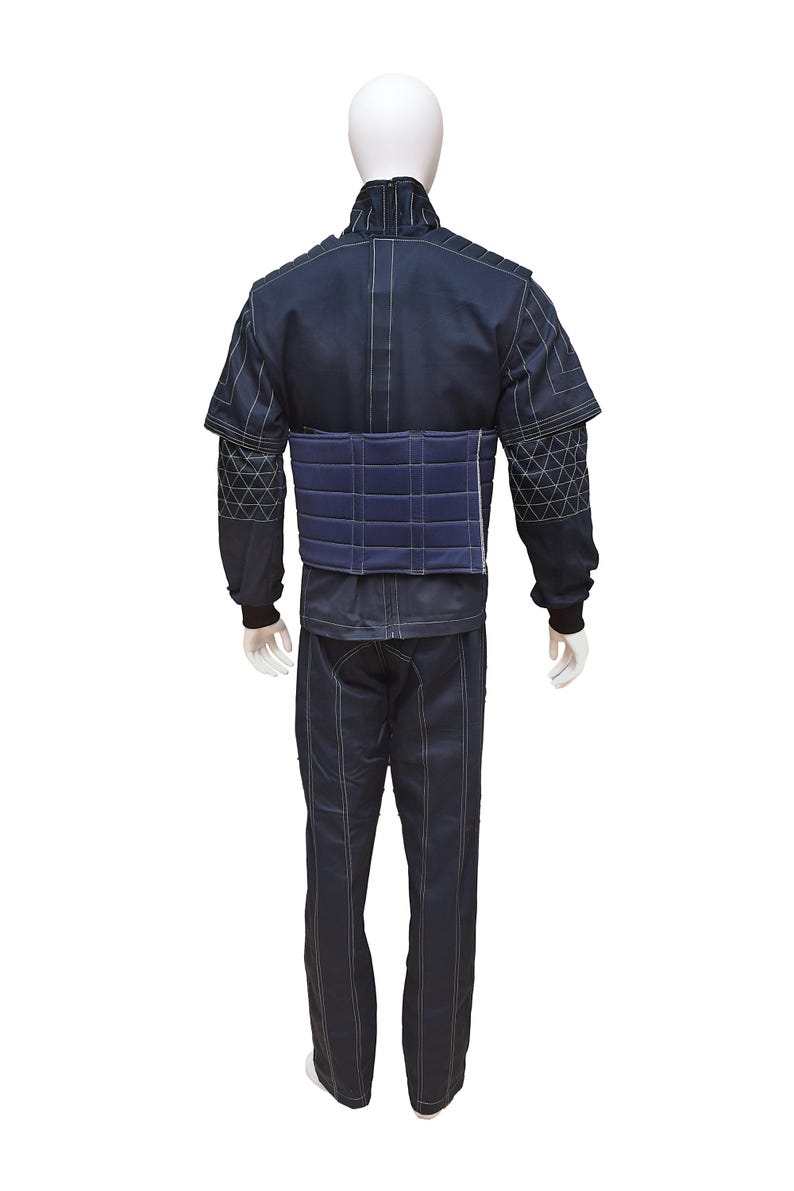 May include: A dark blue padded training suit with a white stitching detail. The suit includes a jacket and pants.