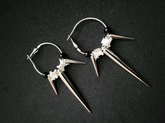 Real snake vertebrae hand-strung into hoop earrings with silver and black beads — 1,059 favorites don't lie, this is the oddity jewelry that actually sells.