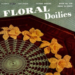 May include: A green crocheted doily with a circular design surrounded by six yellow crocheted flowers. The image is from a vintage book titled "Floral Doilies" with the book number 258 and price 10 cents.