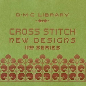 May include: A green cover with the text "D.M.C. LIBRARY" and "CROSS STITCH NEW DESIGNS II ND SERIES" in brown lettering. The cover is decorated with a border of red and brown stylized flowers.