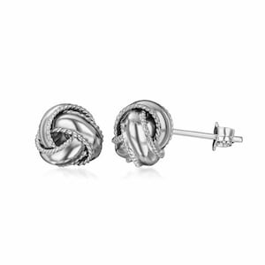 May include: A pair of silver knot-shaped stud earrings. The earrings are made of a smooth, shiny metal and have a simple, elegant design.