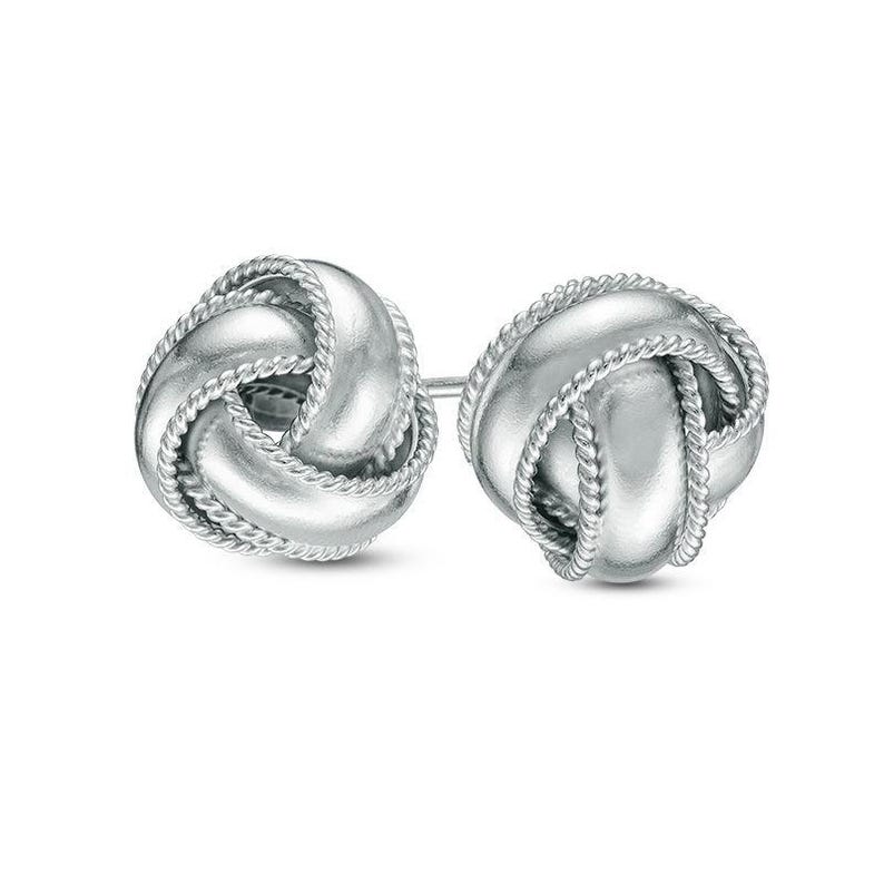 May include: Silver knot earrings with a rope-like design. The earrings are a classic and elegant style.