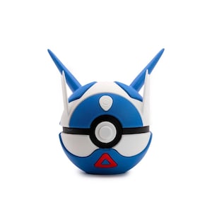 May include: A blue, white, and black spherical toy with a red triangle at the bottom. The toy has two blue, horn-like protrusions and white accents. The toy is a stylized representation of a Poke Ball.