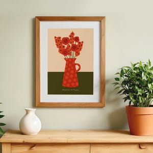 Framed wall art print in red, orange and olive green featuring gladioluses and the poppies in a polka dot vase. There is text below the vase in a hand-written font that lists the flowers.