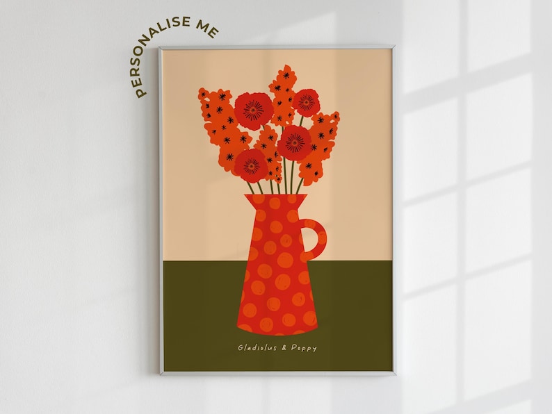 Framed wall art print in red, orange and olive green featuring gladioluses and the poppies in a polka dot vase. There is text below the vase in a hand-written font that lists the flowers.