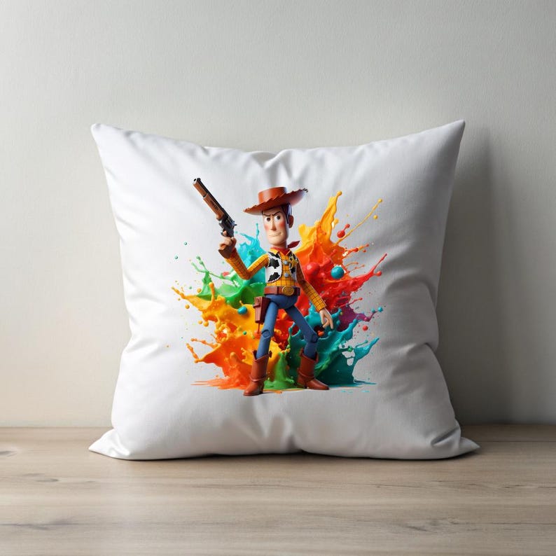 May include: White pillow with a colorful paint splatter design featuring a cartoon image of Woody from Toy Story holding a gun.