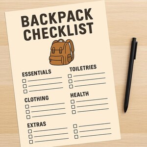 May include: A tan-colored backpack checklist with the title "BACKPACK CHECKLIST" in bold, black letters. The checklist includes sections for essentials, clothing, extras, toiletries, and health. A black pen rests on a light wood surface.