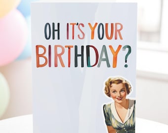 May include: A birthday card with a retro design featuring a woman with a surprised expression and the text "OH IT'S YOUR BIRTHDAY?" in colorful letters.