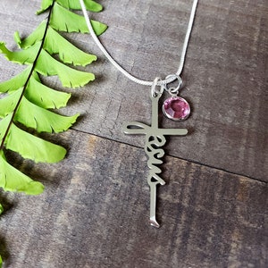 Steel Jesus cross necklace, with a pink zircon birthstone charm.