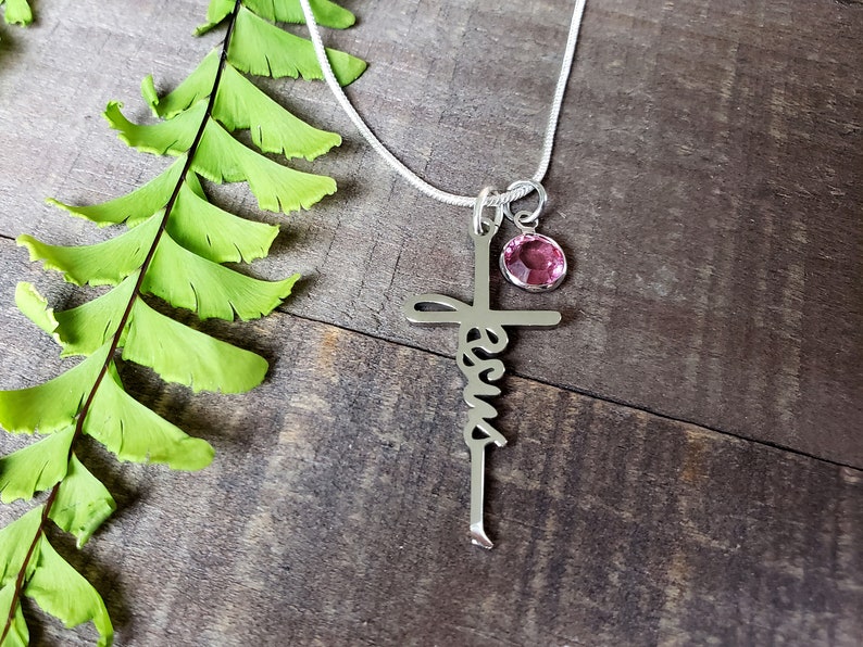 Steel Jesus cross necklace, with a pink zircon birthstone charm.