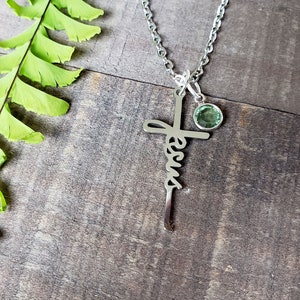 Steel Jesus cross necklace, with a peridot green birthstone charm.