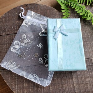 All purchases are lovingly packaged in a small turquoise gift box, safely enclosed in delicate white butterfly organza bag.