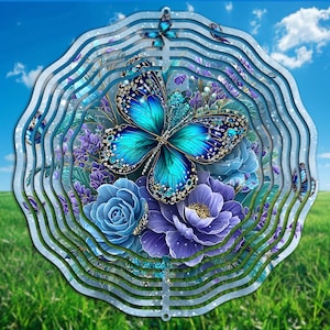 May include: A decorative metal wind spinner featuring a butterfly and floral design. The butterfly has turquoise wings with dark blue accents, surrounded by blue and purple flowers. The background shows a blue sky and green grass.