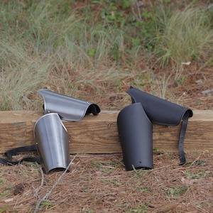 May include: A set of three ceramic mugs with a speckled, matte finish. The mugs are in shades of cream, light gray, and dark gray. Each mug has a simple, minimalist design and a rounded handle.