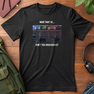 May include: Black t-shirt featuring a colorful graphic of a sound mixing interface with the text "WHAT PART OF... DON'T YOU UNDERSTAND?" The design includes various colored bars and lines, suggesting a music or audio theme. The shirt is made of a soft material.
